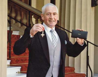 Jim with his MBE at Buckingham Palace